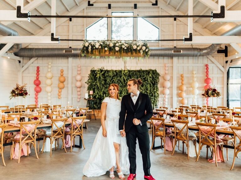Happy couple inside their barn wedding reception
