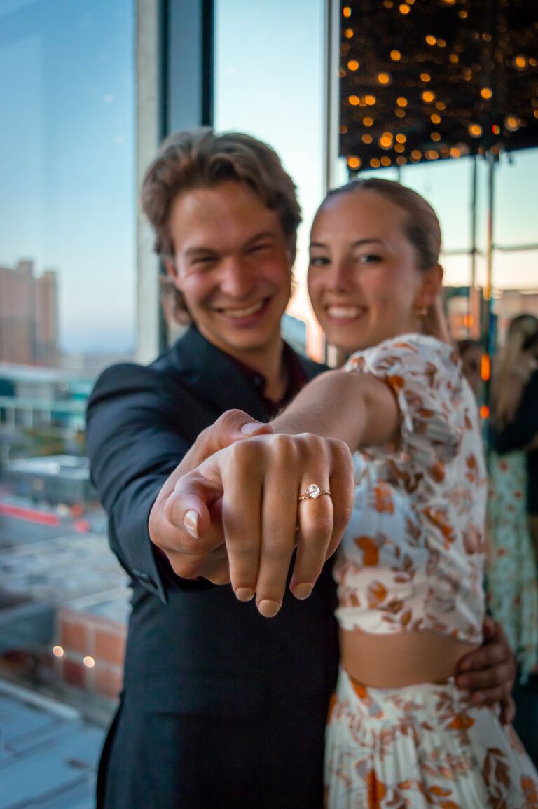 Andrew flew home a day early and surprised Raeleigh at a dinner she was having with her friends, whisked her away to the Mercury Room in KC, and proposed on the balcony at golden hour!