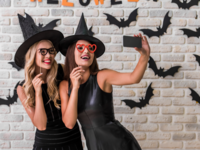 Two girls dressed in halloween costume taking selfie