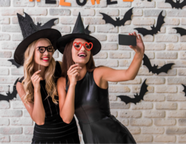 Two girls dressed in halloween costume taking selfie