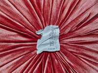 Crumpled receipt on pink velvet background
