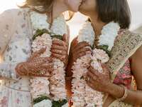 brides kissing during Indian wedding