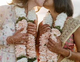 brides kissing during Indian wedding