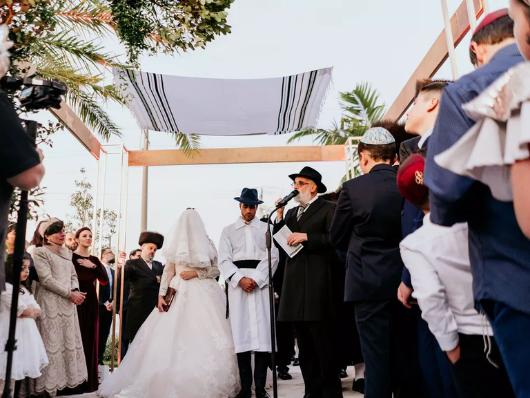 A couple celebrate their Orthodox Jewish Wedding Ceremony