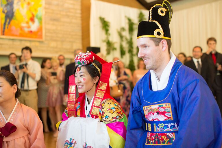 Couple in Korean hanbok attire during wedding ceremony
