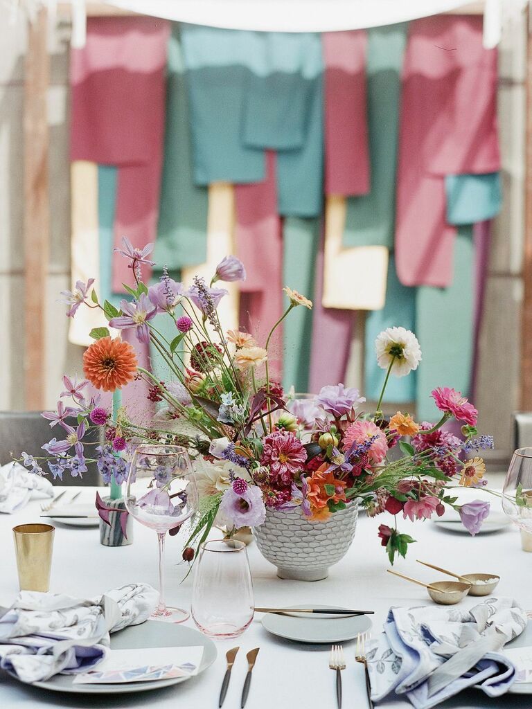 small colorful wedding centerpiece with light purple, pink, orange and white flowers