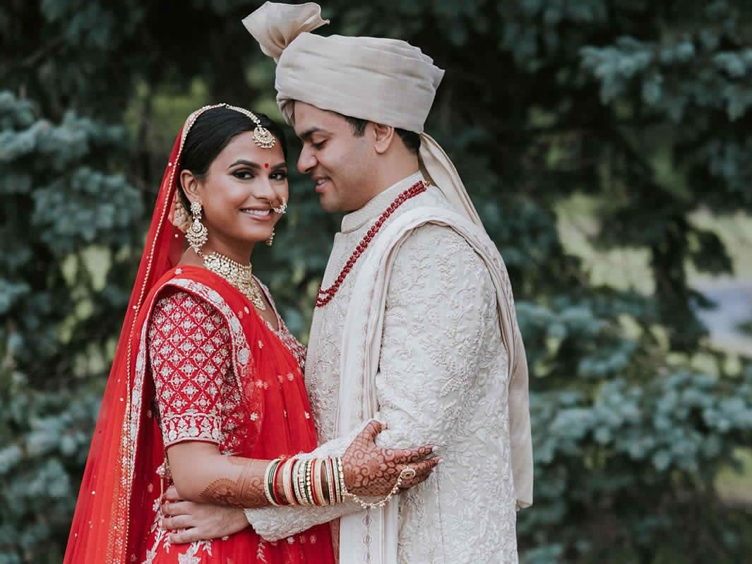 Happy couple holding each other while posing for a portrait