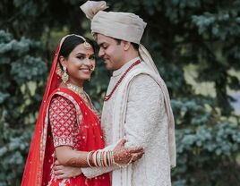 Happy couple holding each other while posing for a portrait