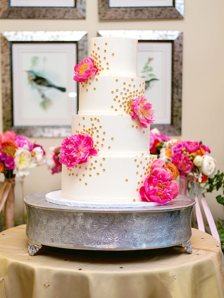 four-tier wedding cake with gold dots and peonies