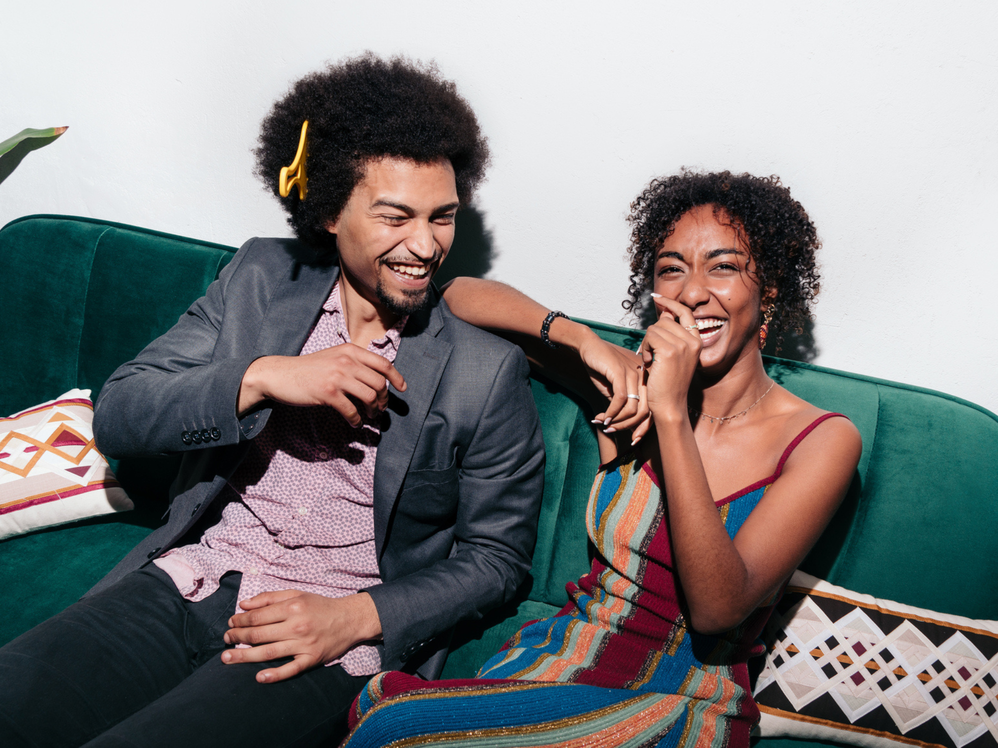 Couple talking and laughing on couch