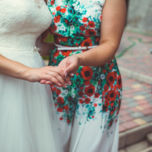 Bride and mother of the bride holding hands