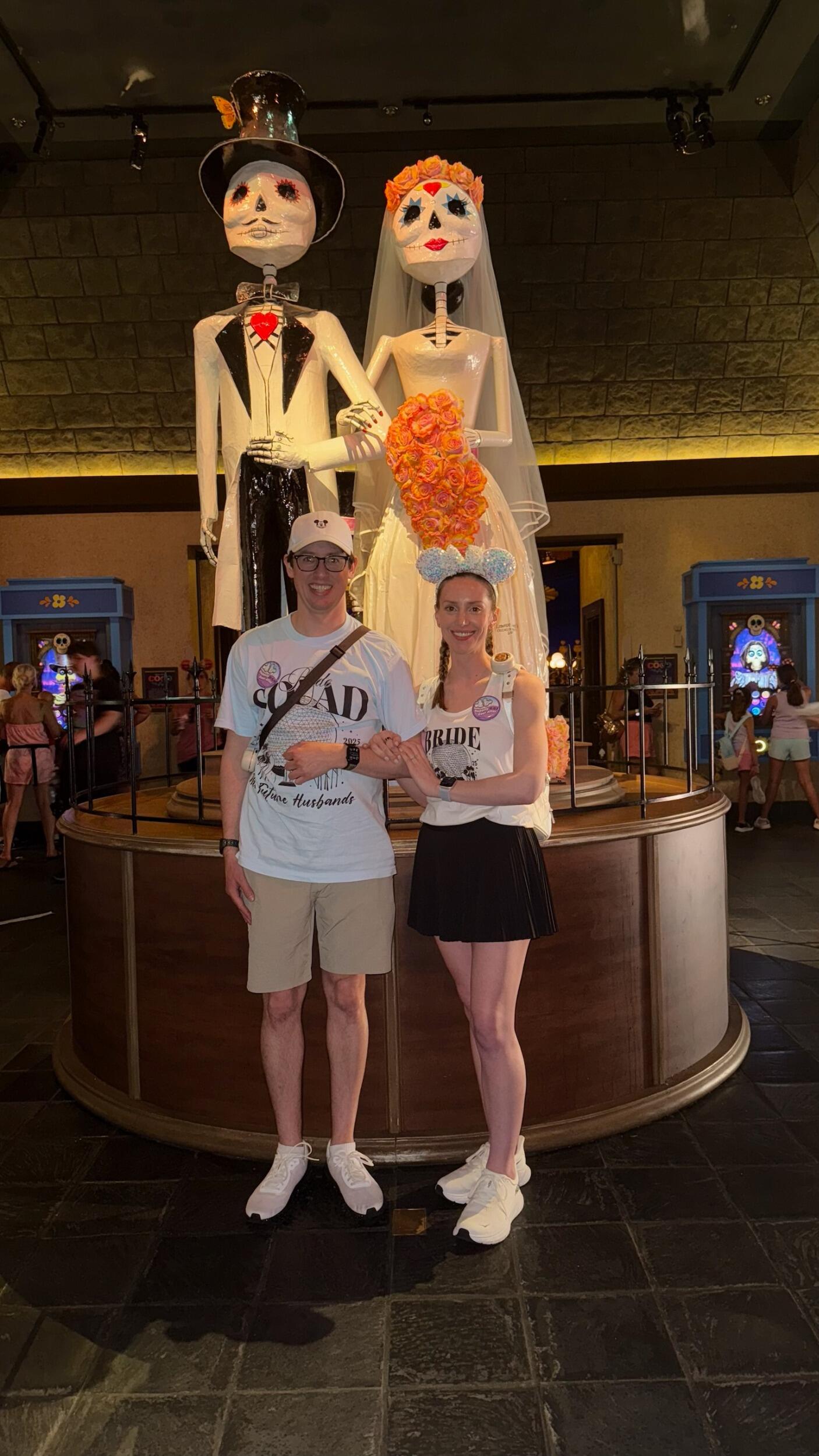 While on their dual engagement Disney World trip with Abby & Thomas, Kirsten & Tyler pose with The Bridal Couple from Día de Muertos in the Mexico Pavilion at Epcot. The couple symbolizes love that will endure long after death.