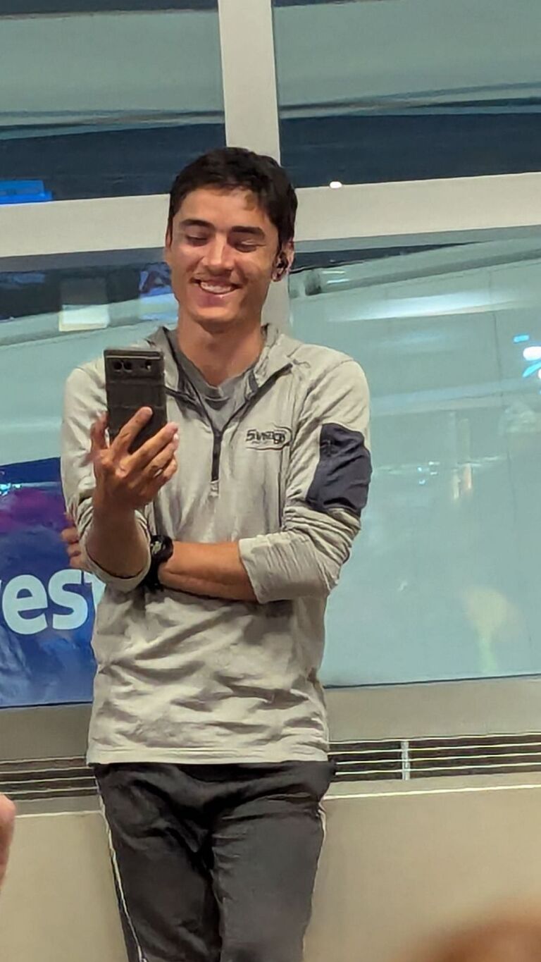 Max with a big smile facetiming Tess while he's supposed to be on vacation with his family (photo courtesy of Jace)