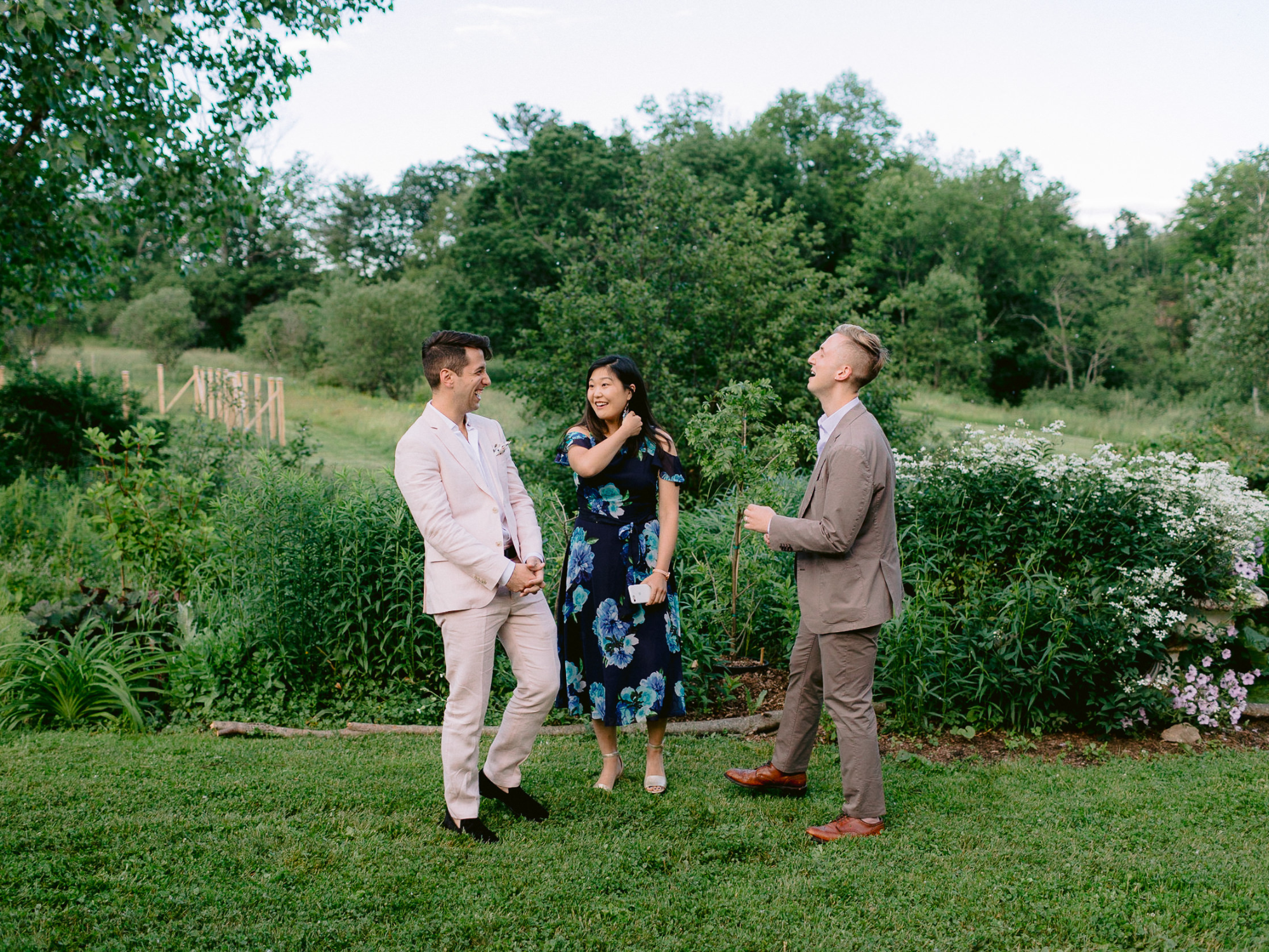 Guests laughing with each other at outdoor rehearsal dinner venue