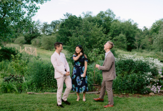 Guests laughing with each other at outdoor rehearsal dinner venue