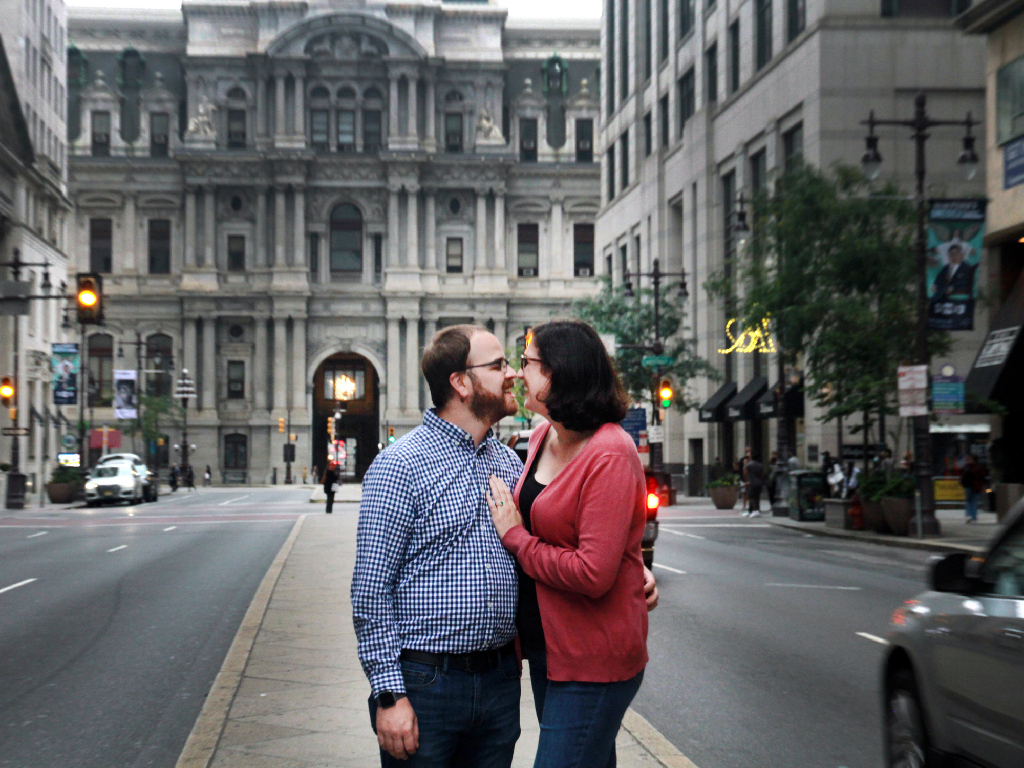 Couple smiling at each other and hugging in downtown Philadelphia, Pennsylvania