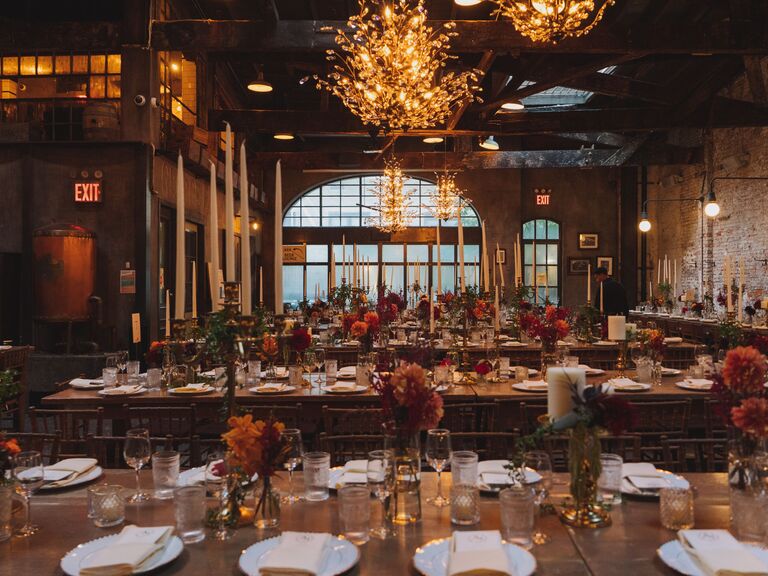 Rustic reception space with exposed brick walls, unique lighting fixtures and candles