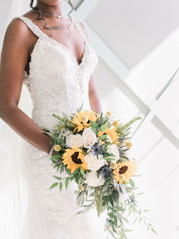 bride holding cascading sunflower bouquet