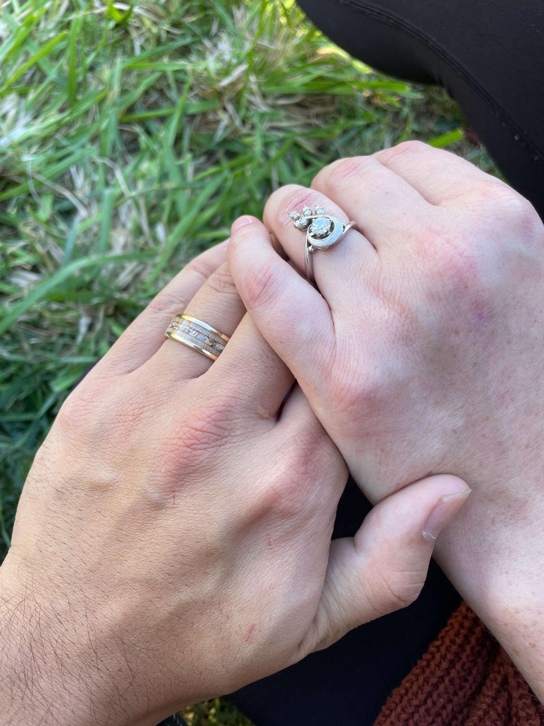 And that brings us to today. This photo is of the ring Katie had custom made for Eric. She wanted Eric to have something as special as the inherited engagement ring he proposed to her with. Her family didn't have any heirlooms like that, so she made her own. My dad provided the walnut from a tree he grew up playing on and collecting walnuts to sell during the summer and fall. My mom collected the stones from the spring, a place very near and dear to her and her side of the family, and the place where we will marry. I gave the ring to him under an apple tree during our anniversary date! Now he has something passed down through my family to him. 