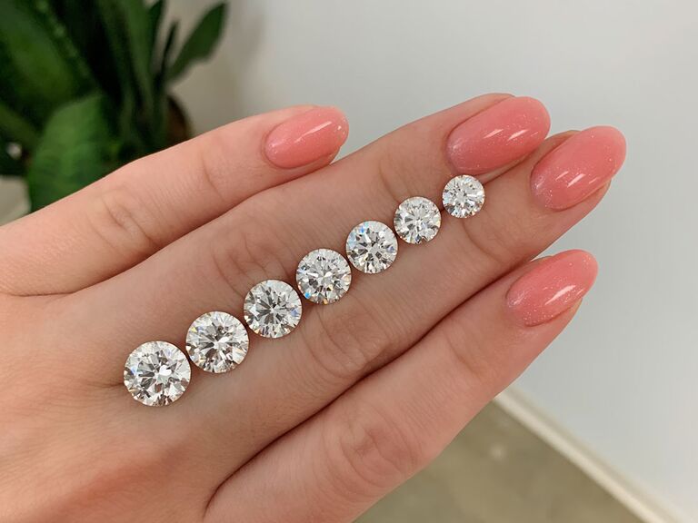 Seven different diamond carat sizes on a hand
