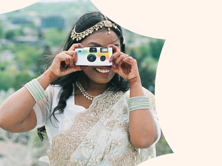 women with camera taking candid photos at wedding