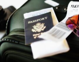 passport with luggage packed for travel 