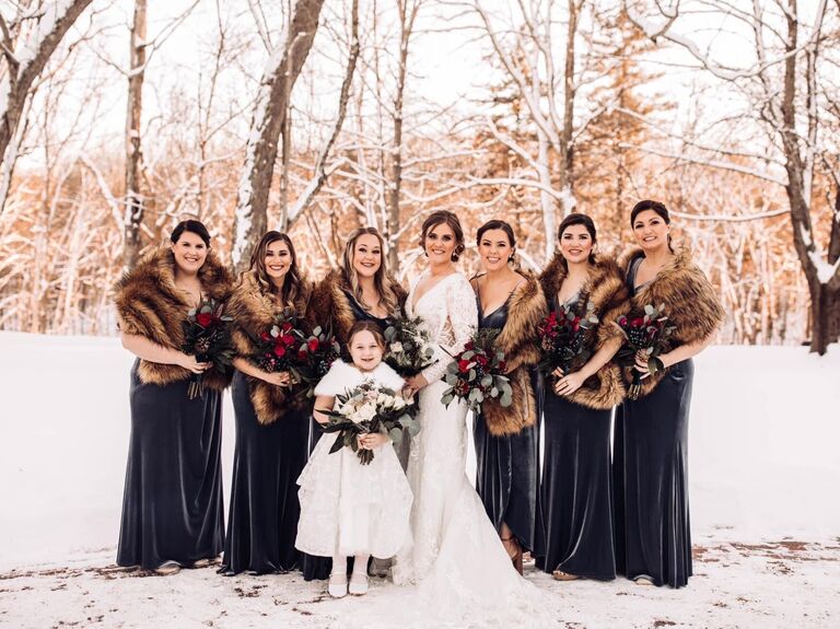 Bride and wedding party posing for a picture in a winter backdrop