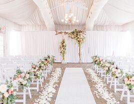 Bright and airy ceremony space with a wooden arch