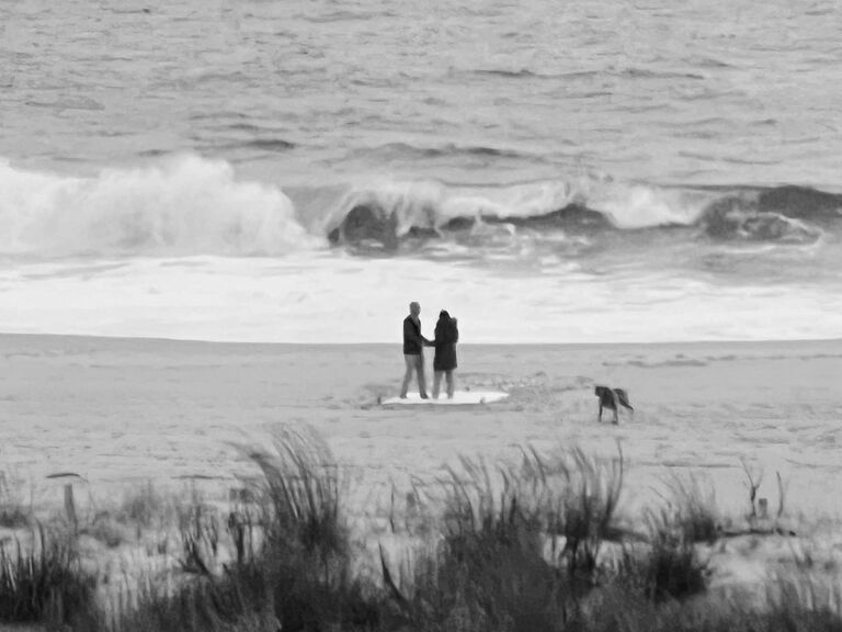 On this cold and rainy day, Mike and I made our way down to OC for our annual St. Patty Day trip. When we get there he was adamant on us walking the dogs down the beach. Me being stubborn, initially did not want to go because it was raining but I agreed anyways, We get to the beach and we walk up to what looks like a proposal set up and I turn to Mike and sarcastically go "oh great it looks like someone is getting engaged ugh". He pulls me over there and by surprise it was for ME!!! The same place we met in 2012. Obviously I said YES and that's why you're on this website in the first place. 
