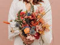 colorful boho wedding bouquet with pink, orange and yellow abstract flowers