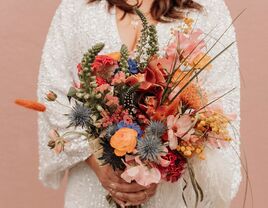 colorful boho wedding bouquet with pink, orange and yellow abstract flowers