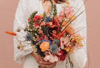 colorful boho wedding bouquet with pink, orange and yellow abstract flowers