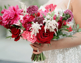 Bride holding pink, white, and red wedding bouquet.