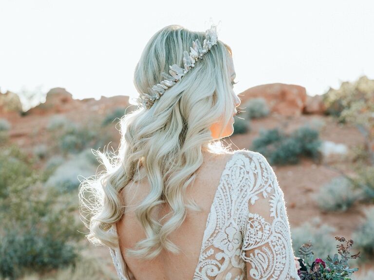 Bride wears her hair in long, loose waves. 