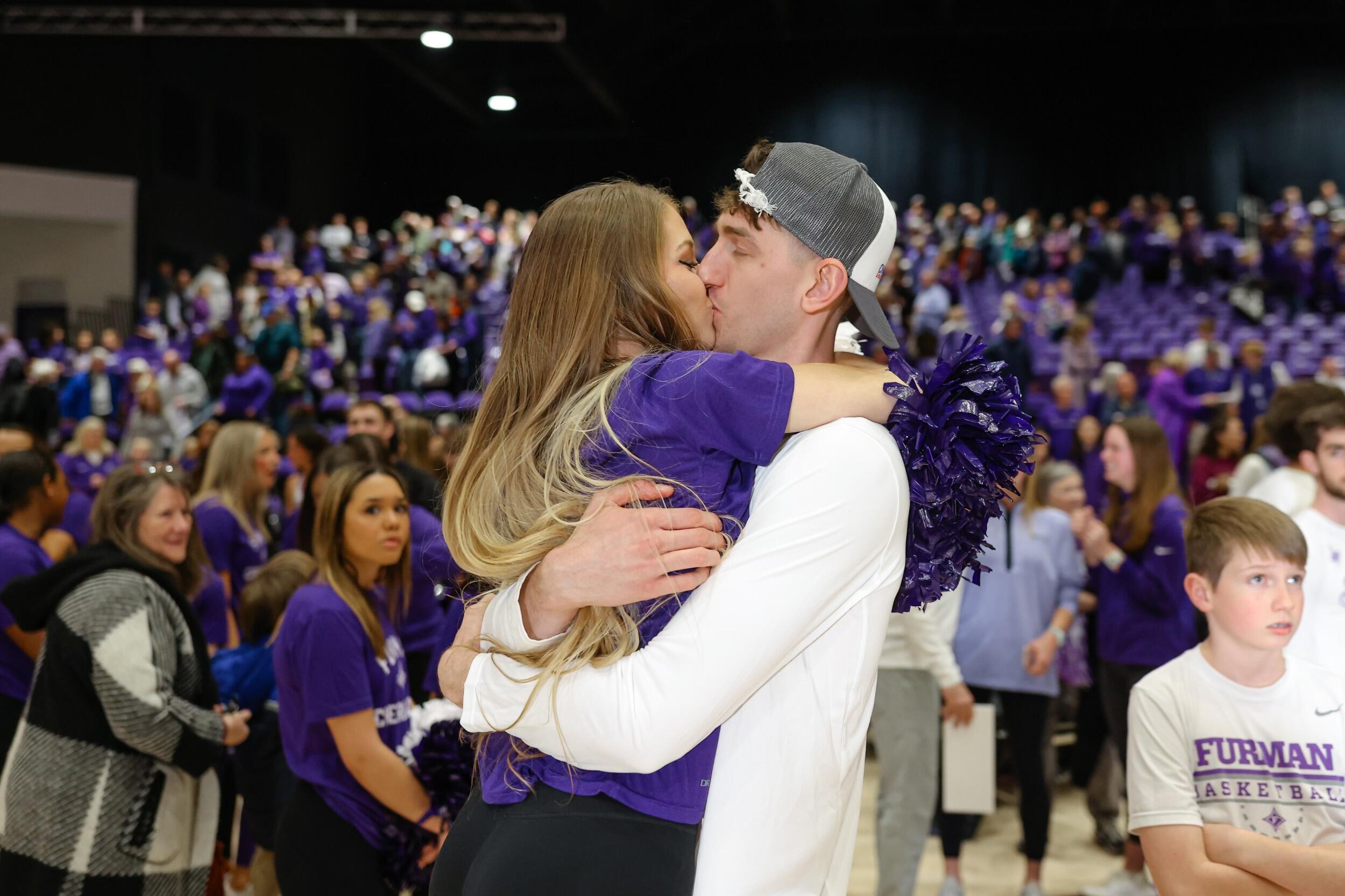 Meredith jumping into Jonny's arms captured during the March Madness Selection Sunday. She was so excited for Jonny and his team to play in his hometown!