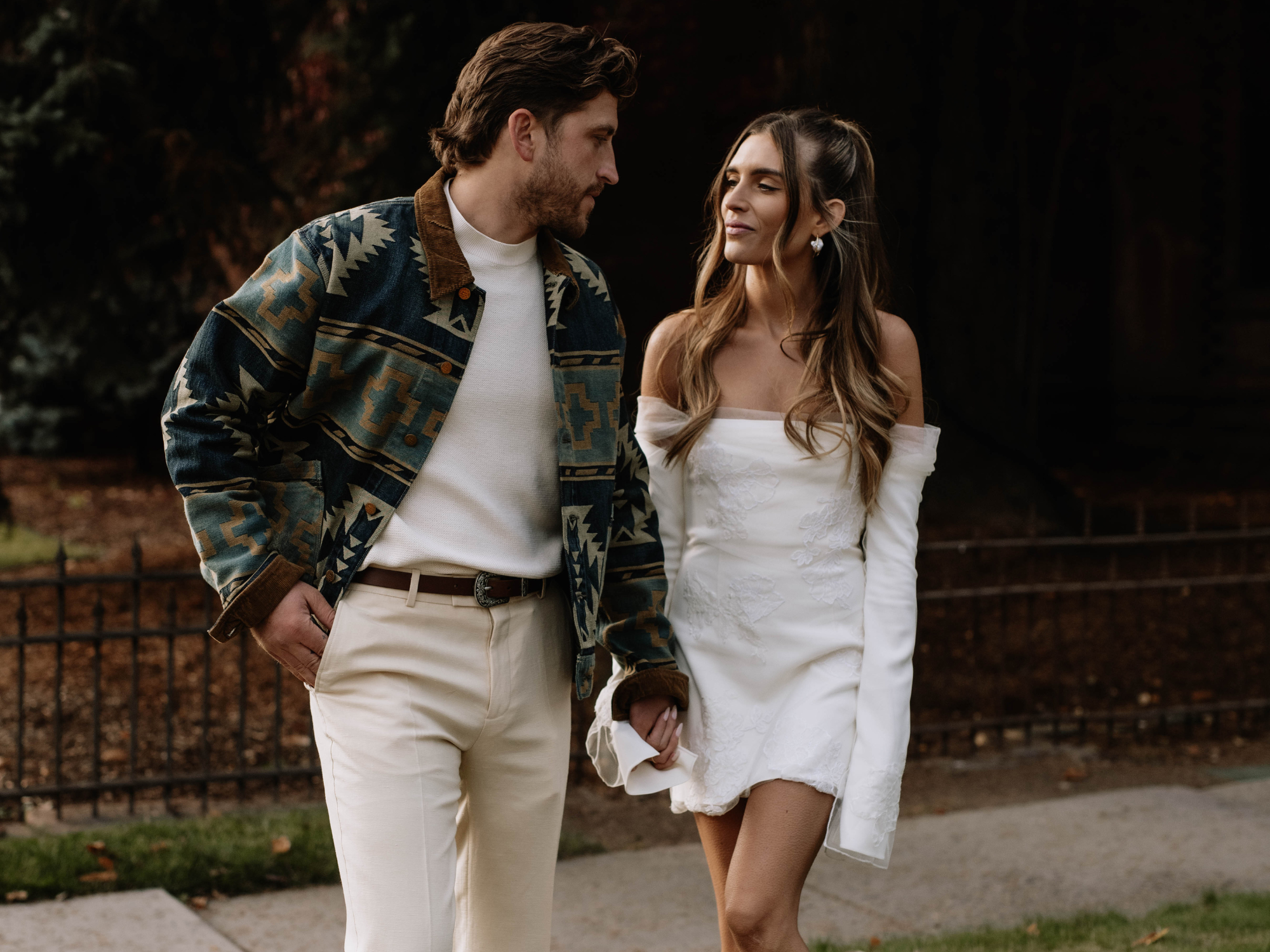 Couple looking at each other holding hands in the fall