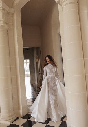 Stylish guipure mermaid silhouette with an over-skirt descending from the outlined waistline. Intricately decorated with floral accents, the turtleneck and mermaid skirt are complemented with a sleek voluminous train.
