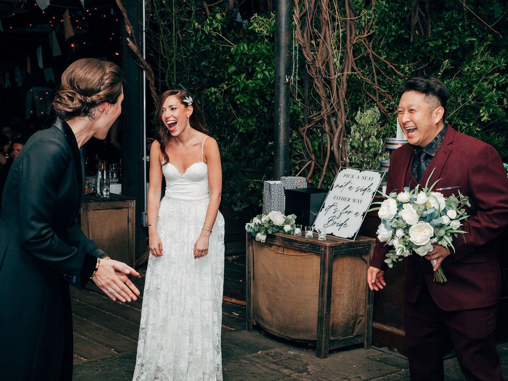 Photo from wedding ceremony with bride and wedding planner laughing