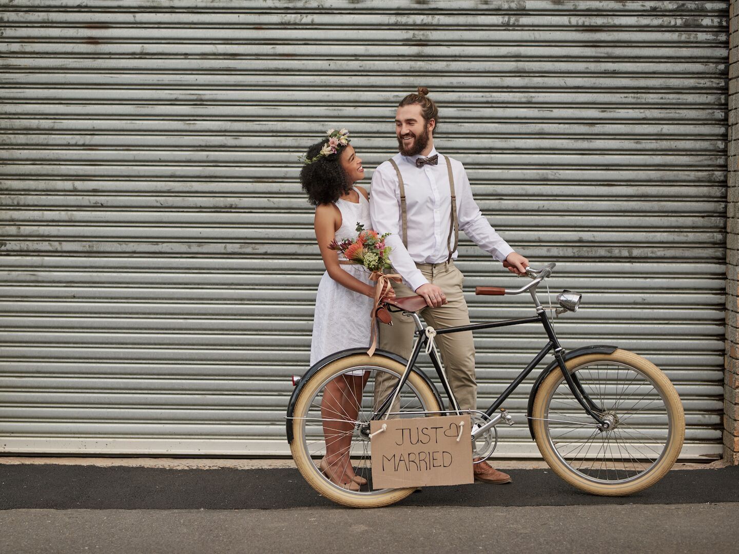 How Much Does It Cost to Elope? Newlywed couple with bicycle