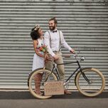 How Much Does It Cost to Elope? Newlywed couple with bicycle