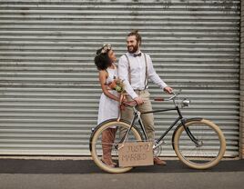 How Much Does It Cost to Elope? Newlywed couple with bicycle