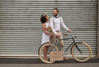How Much Does It Cost to Elope? Newlywed couple with bicycle