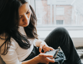 confused woman looking at her phone