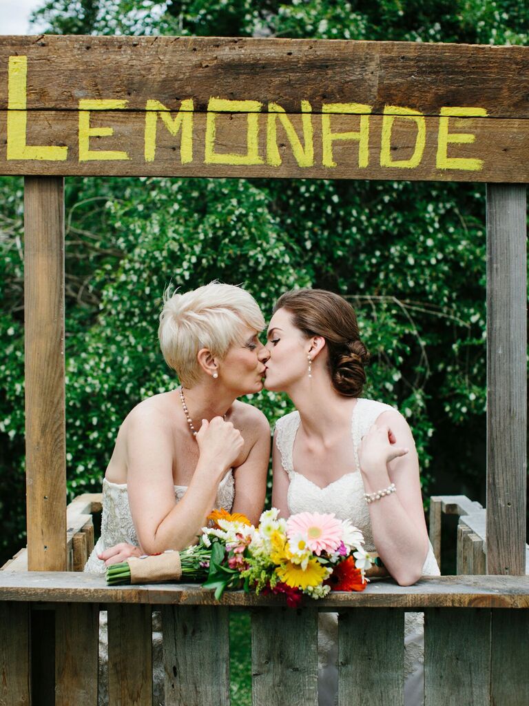 Wooden lemonade stand at backyard wedding