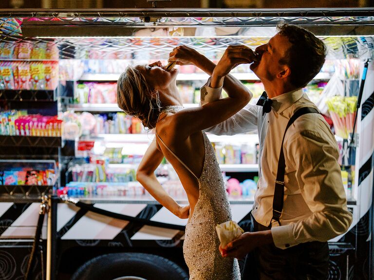Bride and groom enjoying late night snack after wedding in gas station