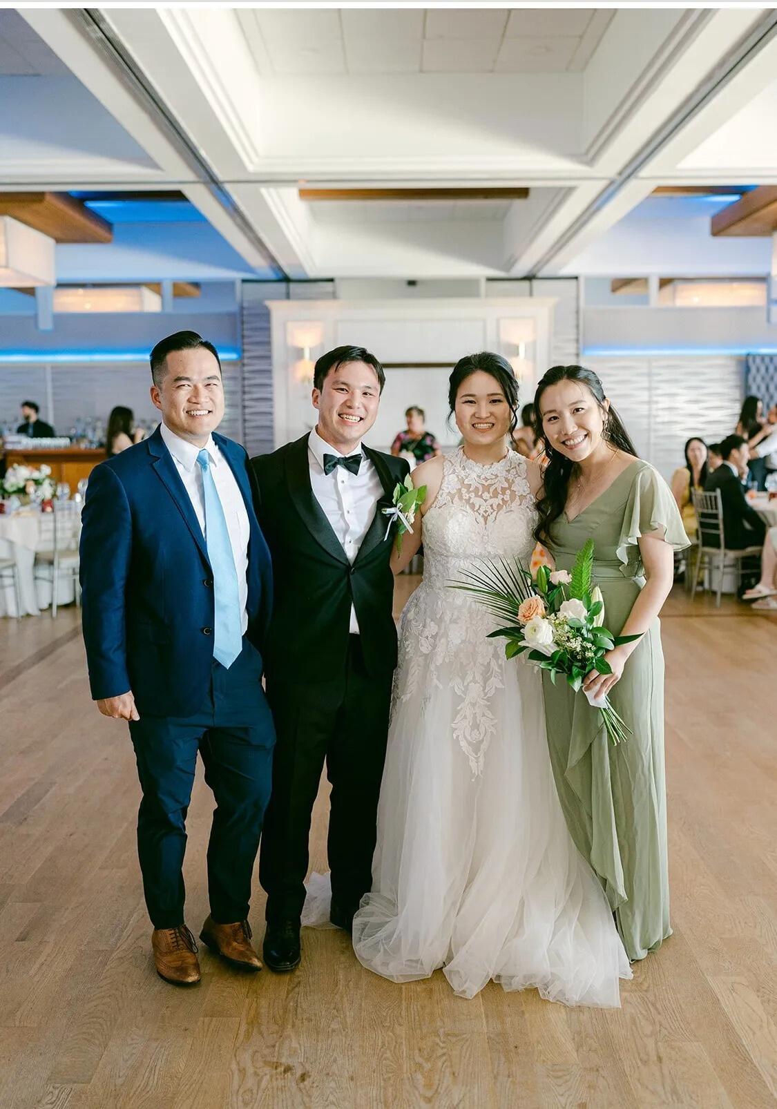 Lan got the flower during the Bouquet Toss at Hattie & Tommy's wedding! Michael tried not to seem too nervous in the picture.