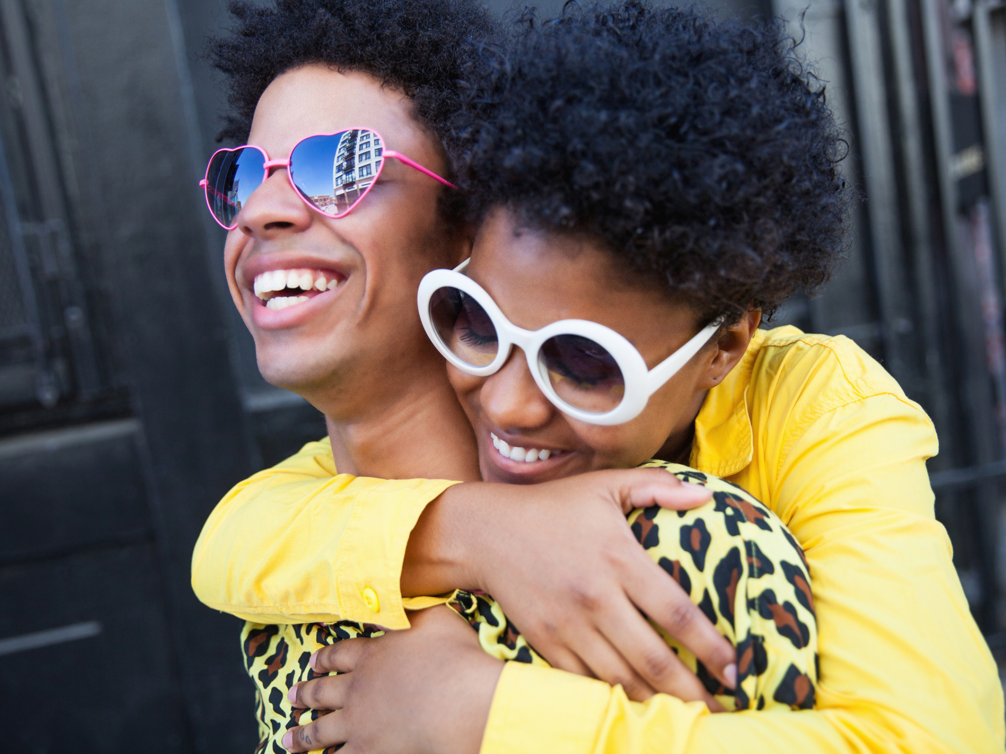 A young woman hugging her boyfriend from behind