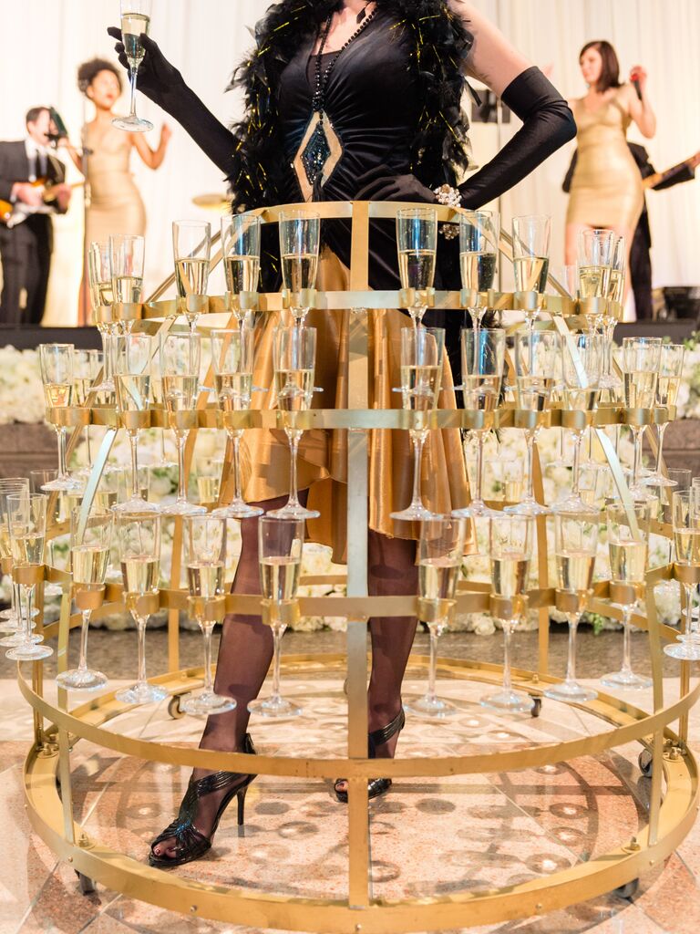 flapper impersonator wearing metal hoop skirt and built-in champagne flute holders