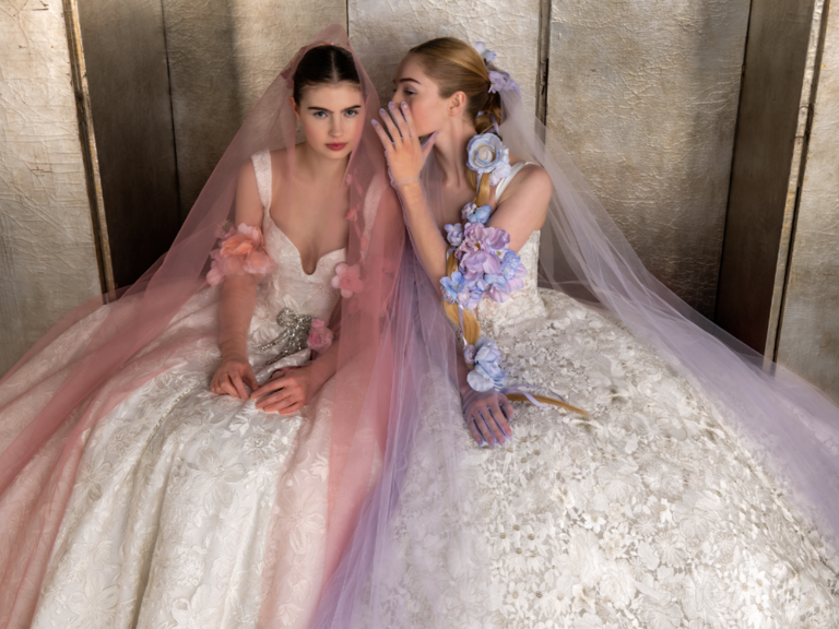 Two models wearing pastel bridal gowns at Bridal Fashion Week