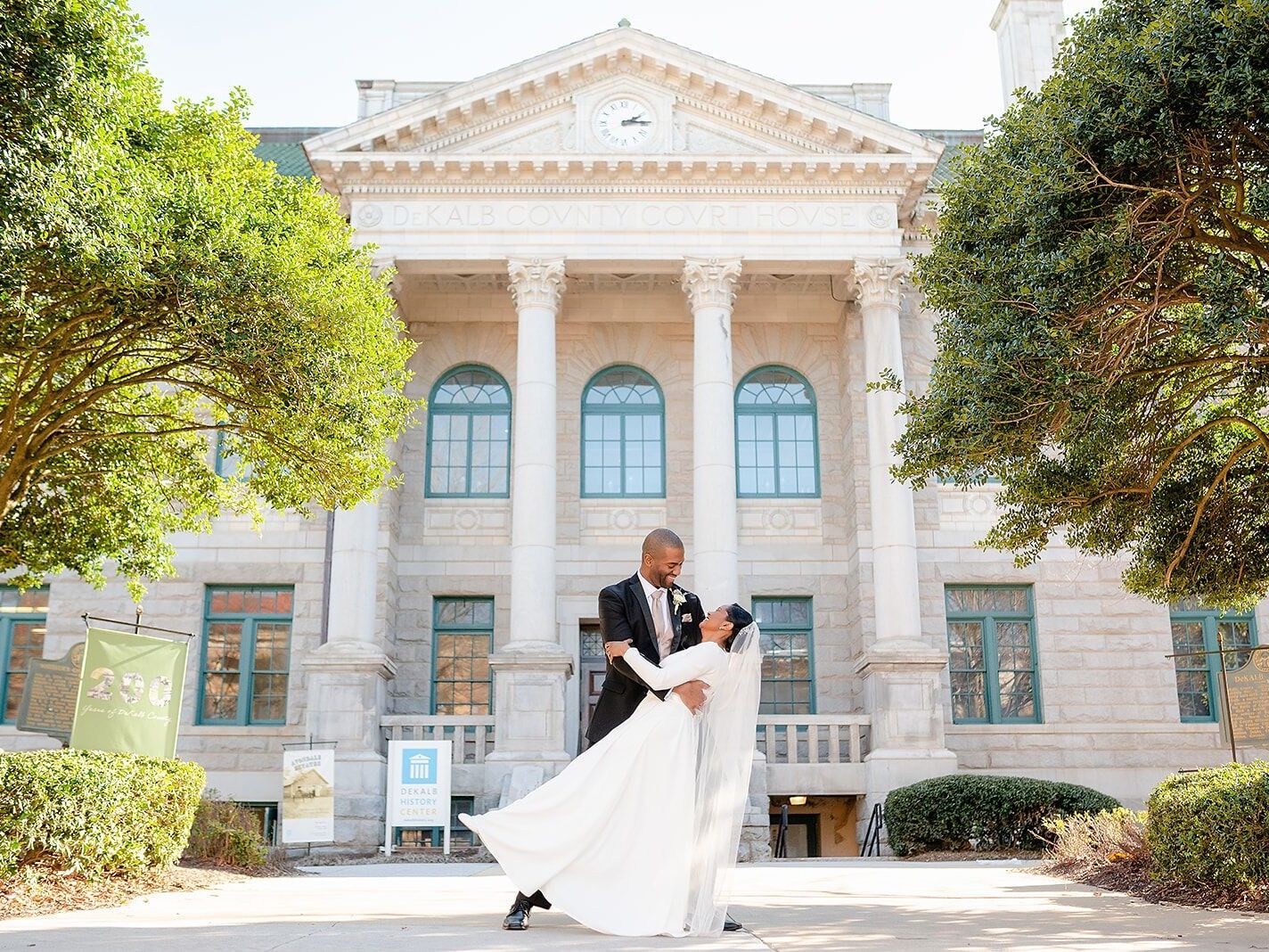 Couple posing outside the Historic DeKalb Courthouse
